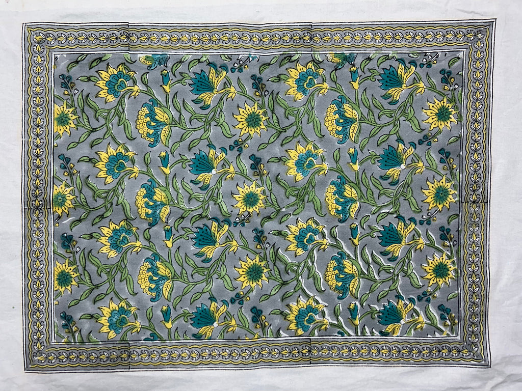 Hand block printed all-over floral table mat in grey-blue, yellow and teal