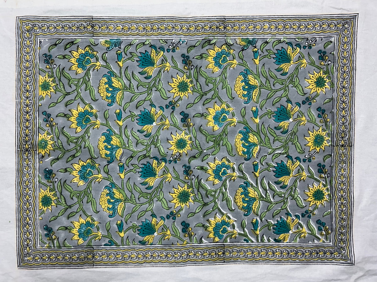 Hand block printed all-over floral table mat in grey-blue, yellow and teal